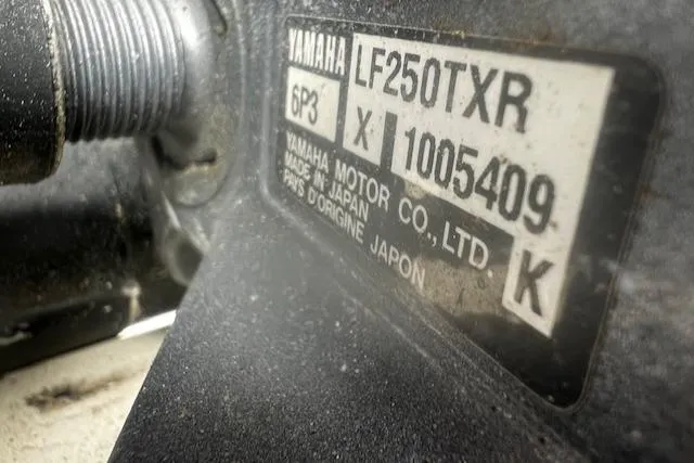 Slide: The Image of Close-up of Yamaha LF250TXR engine label on a 1999 Contender 27 Open Center Console. - 12