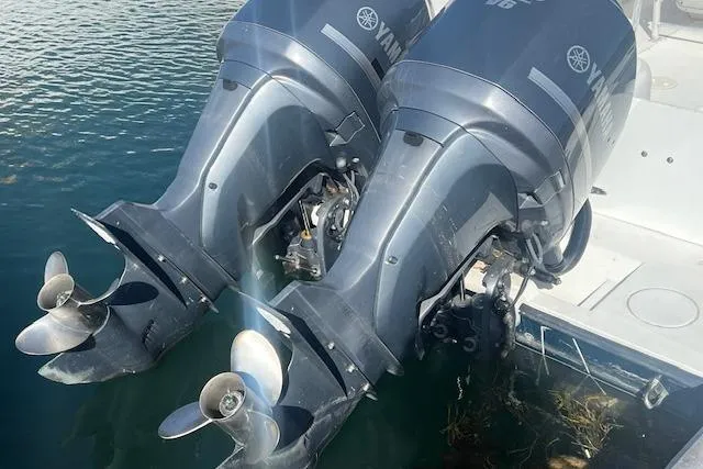 Slide: The Image of Twin Yamaha outboard motors on a 1999 Contender 27 Open Center Console boat. - 21