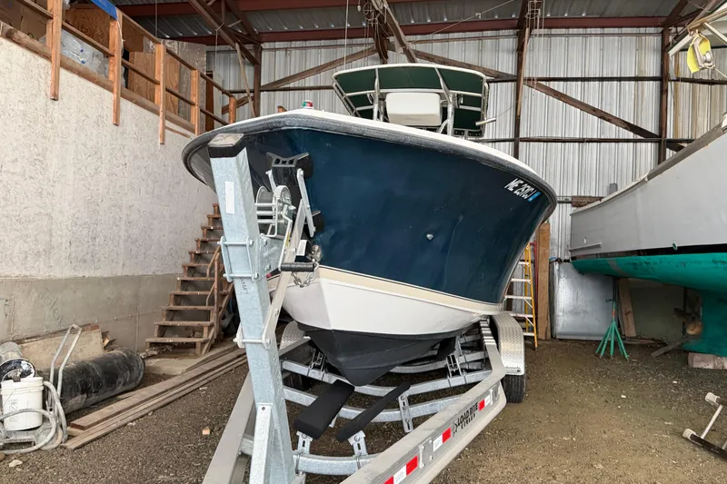 Slide: The Image of 1999 Contender 27 Open CC boat on trailer in storage facility. - 25