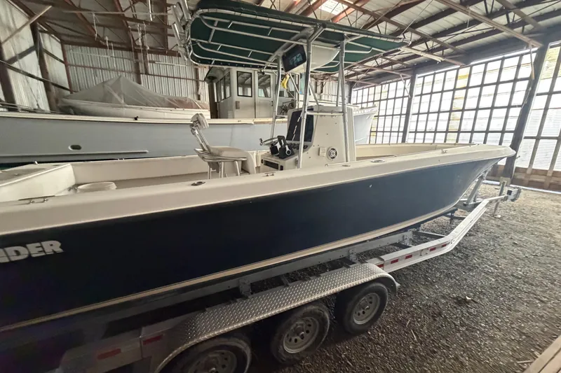 Slide: The Image of 1999 Contender 27 Open CC boat on trailer in storage facility. - 26