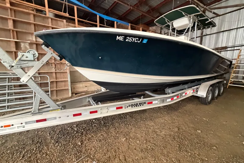 Slide: The Image of 1999 Contender 27 Open CC boat on trailer in storage facility. - 27