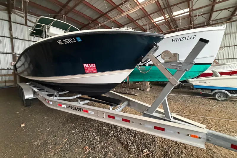 Slide: The Image of 1999 Contender 27 Open CC boat on trailer, for sale in storage facility. - 28