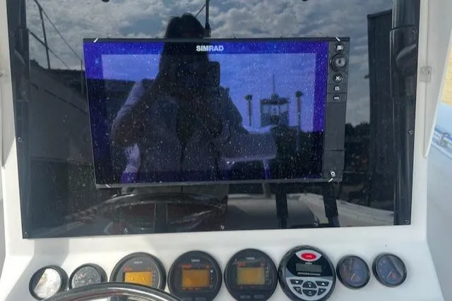 Slide: The Image of 1999 Contender 27 Open Center Console dashboard with Simrad display and gauges. - 3