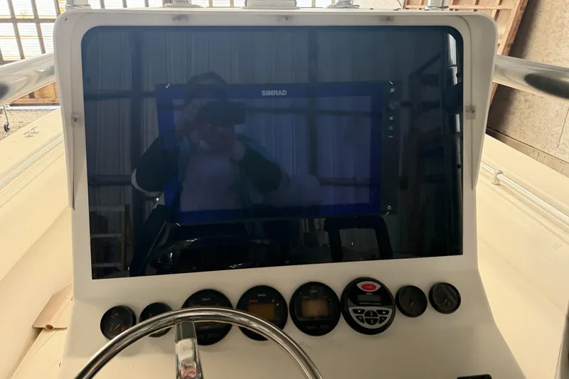 Slide: The Image of Console of a 1999 Contender 27 Open CC boat with navigation equipment. - 33