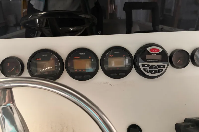 Slide: The Image of Dashboard of a 1999 Contender 27 Open CC boat with Yamaha gauges. - 34