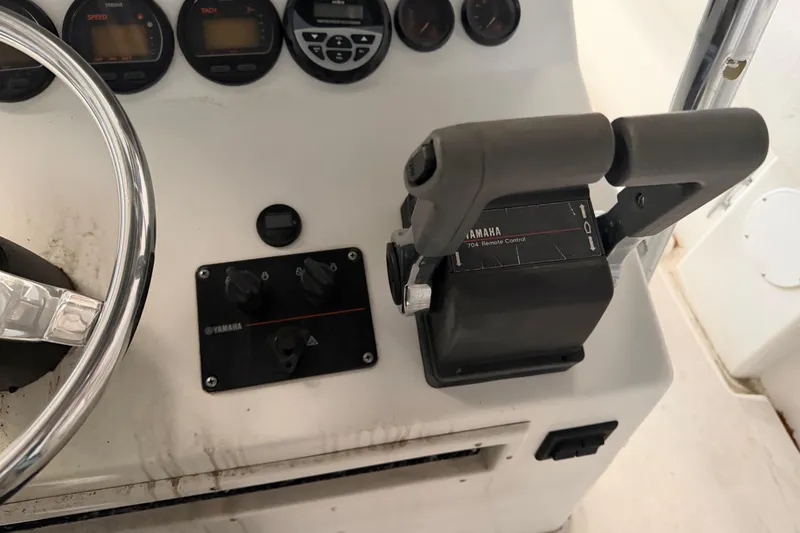Slide: The Image of Control panel of a 1999 Contender 27 Open CC boat with Yamaha throttle. - 35