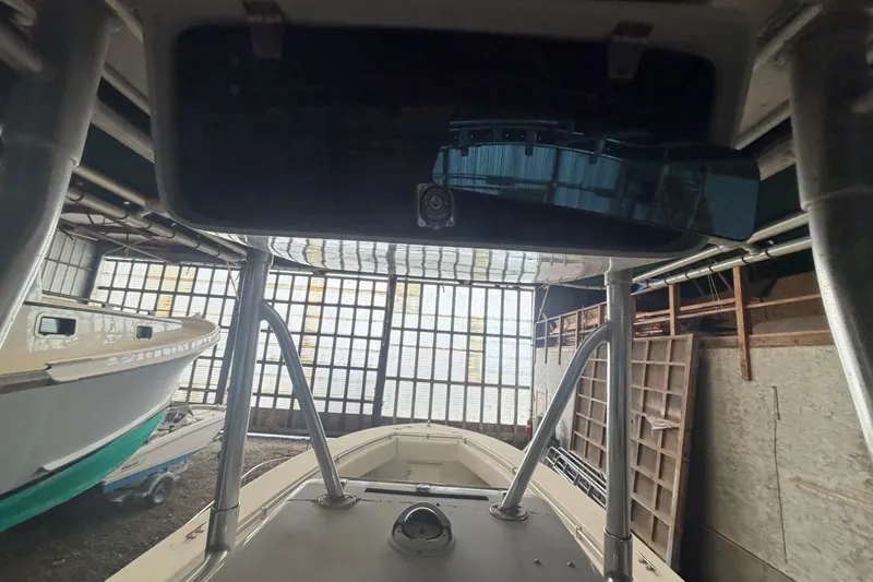 Slide: The Image of Interior view of a 1999 Contender 27 Open CC boat, featuring rod holders and speaker. - 40