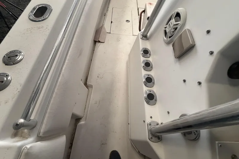 Slide: The Image of 1999 Contender 27 Open CC boat in storage, featuring spacious deck and T-top canopy. - 42