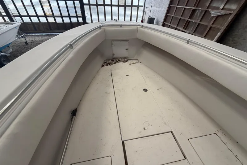 Slide: The Image of 1999 Contender 27 Open CC boat interior with steering wheel and seating. - 43