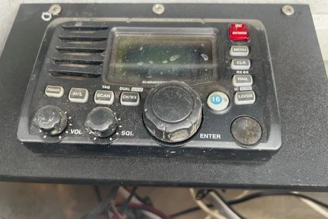 Slide: The Image of Close-up of a marine radio control panel on a 1999 Contender 27 Open Center Console boat. - 5