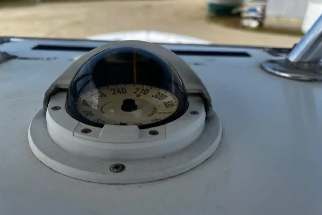 Slide: The Image of Compass on 1999 Contender 27 Open Center Console boat dashboard. - 6