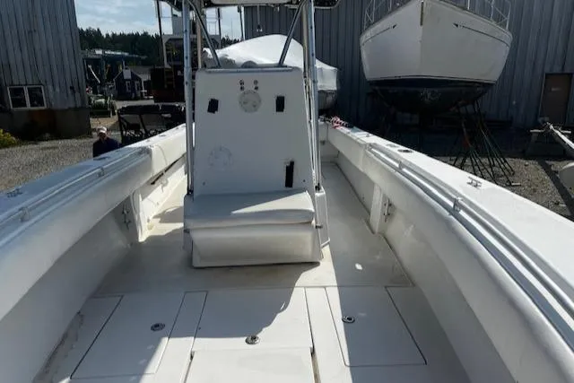 Slide: The Image of 1999 Contender 27 Open Center Console boat, white interior, docked at a marina. - 8
