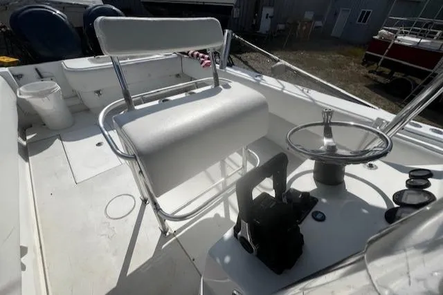 Slide: The Image of 1999 Contender 27 Open Center Console boat interior with steering wheel and seating. - 9