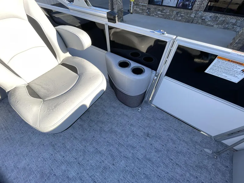 Slide: The Image of 2025 South Bay 224ULLE boat interior with cushioned seat and cup holders. - 13