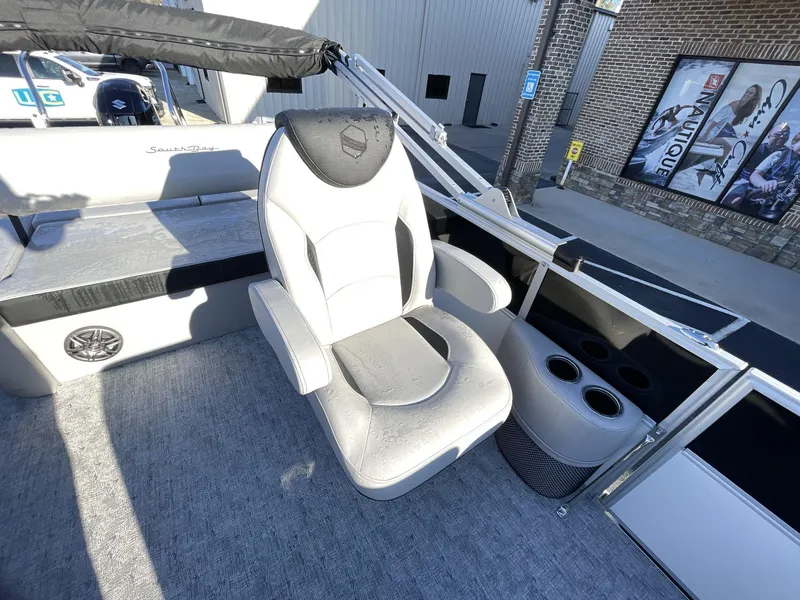 Slide: The Image of Luxurious seating on 2025 South Bay 224ULLE pontoon boat with cup holders and speaker. - 14