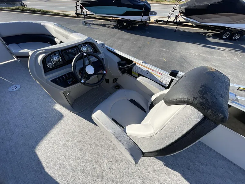 Slide: The Image of 2025 South Bay 224ULLE boat cockpit with steering wheel and seating. - 15