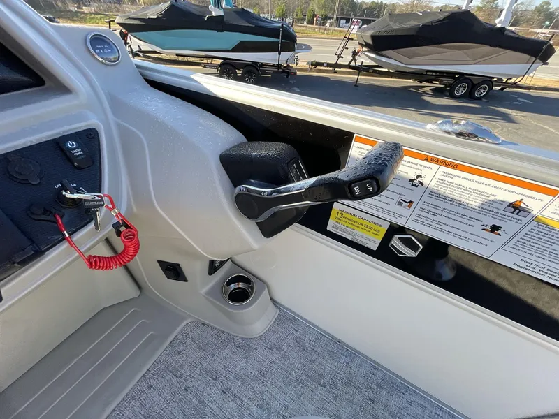 Slide: The Image of 2025 South Bay 224ULLE boat control panel with throttle and safety instructions. - 16