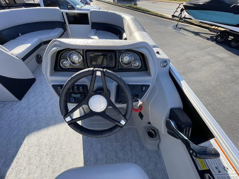 Slide: The Image of 2025 South Bay 224ULLE boat dashboard with steering wheel and control panel. - 17