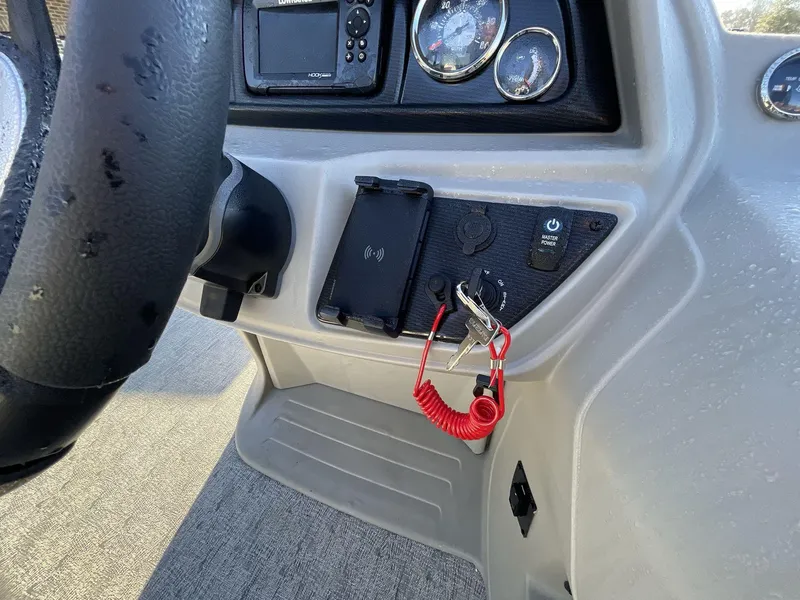 Slide: The Image of Steering console of 2025 South Bay 224ULLE boat with gauges and controls. - 19