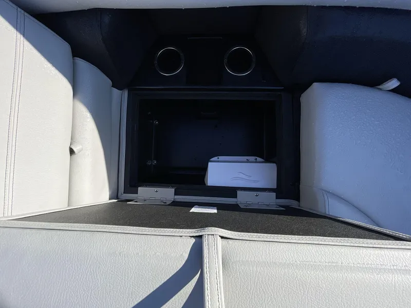 Slide: The Image of Interior storage compartment of 2025 South Bay 224ULLE boat with cup holders. - 21