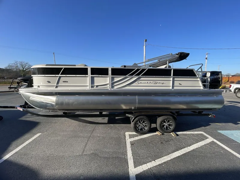Slide: The Image of 2025 South Bay 224ULLE pontoon boat on trailer under clear blue sky. - 3