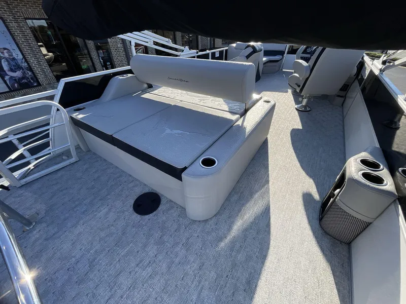Slide: The Image of 2025 South Bay 224ULLE pontoon boat interior with gray seating and cup holders. - 9