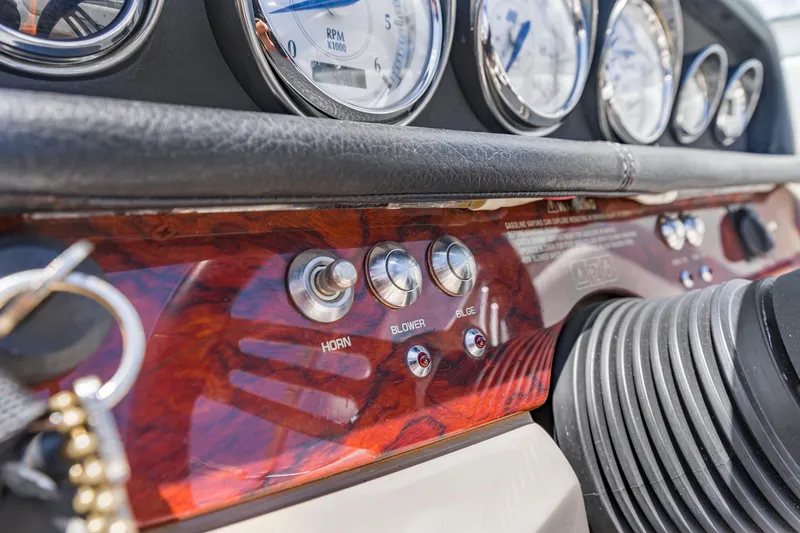 Slide: The Image of Dashboard of 2008 Four Winns F224 boat with gauges and control switches. - 14