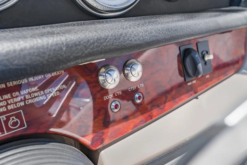 Slide: The Image of Dashboard controls of a 2008 Four Winns F224 boat, featuring dock and courtesy lights. - 16
