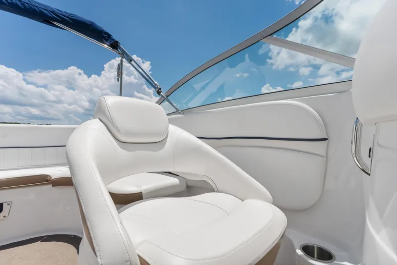 Slide: The Image of 2008 Four Winns F224 boat interior with white seating and blue sky background. - 25