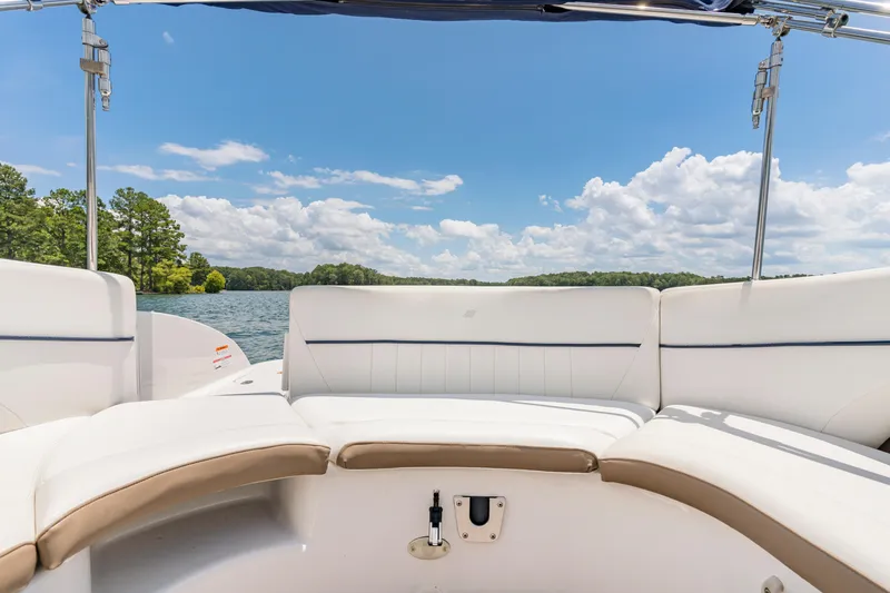 Slide: The Image of 2008 Four Winns F224 boat interior with white seating, lake view, and blue sky. - 4