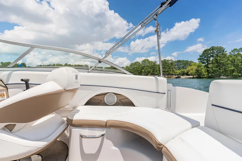 Slide: The Image of 2008 Four Winns F224 boat interior with white seating, on a sunny lake day. - 5