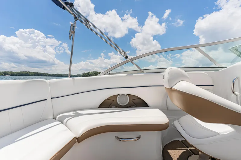 Slide: The Image of 2008 Four Winns F224 boat interior with white seating, blue sky, and lake view. - 6