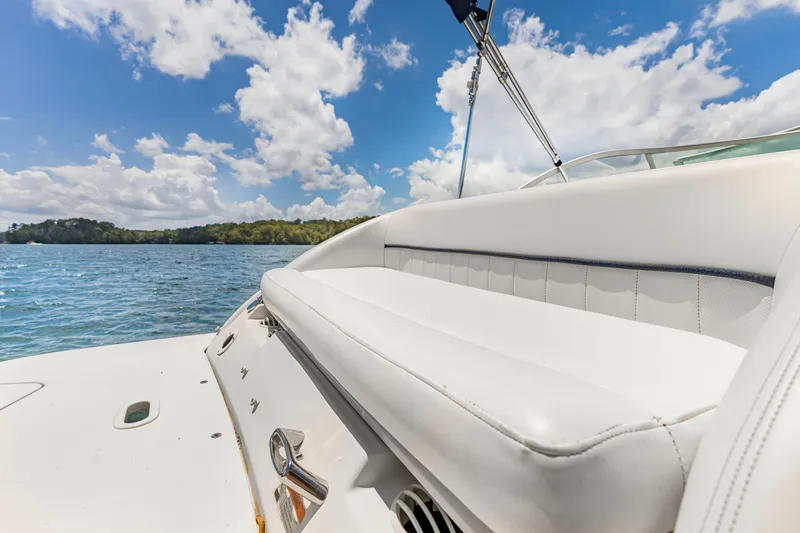 Slide: The Image of 2008 Four Winns F224 boat interior with white seating, set against a scenic lake view. - 8