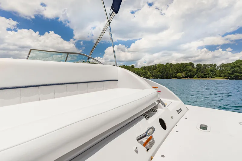 Slide: The Image of 2008 Four Winns F224 boat on a lake, featuring white seating and clear skies. - 9
