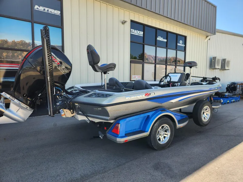 Slide: The Image of 2019 Ranger Z518 boat with trailer parked outside a dealership. - 2