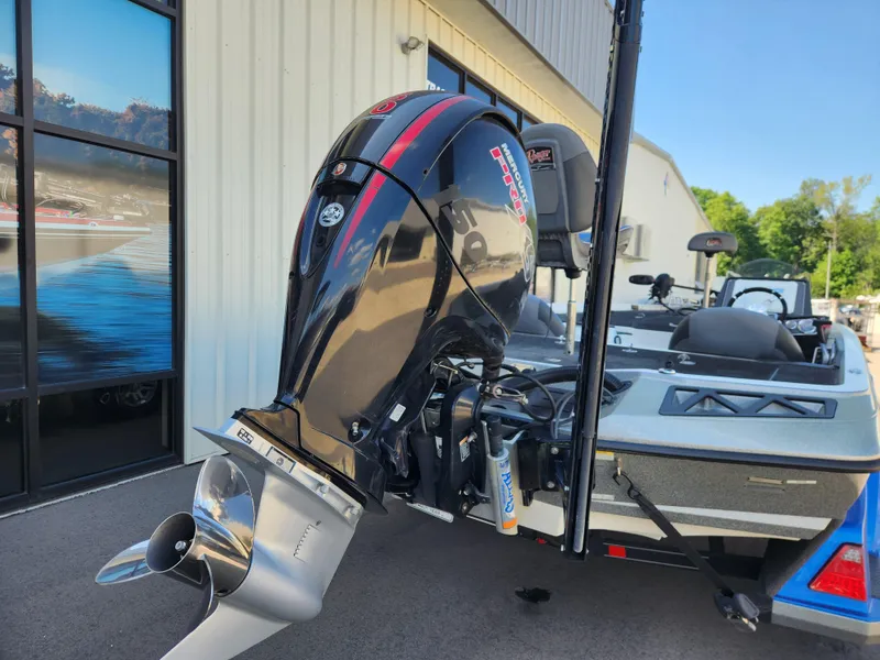 Slide: The Image of 2019 Ranger Z518 boat with powerful outboard motor, parked near a building. - 3