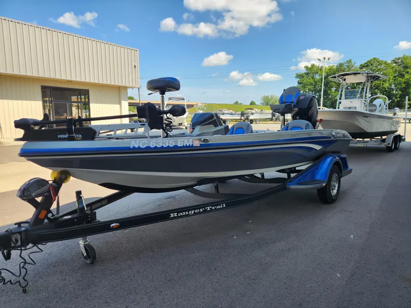 Slide: The Image of 2019 Ranger Z518 boat on trailer, parked outdoors under blue sky. - 6