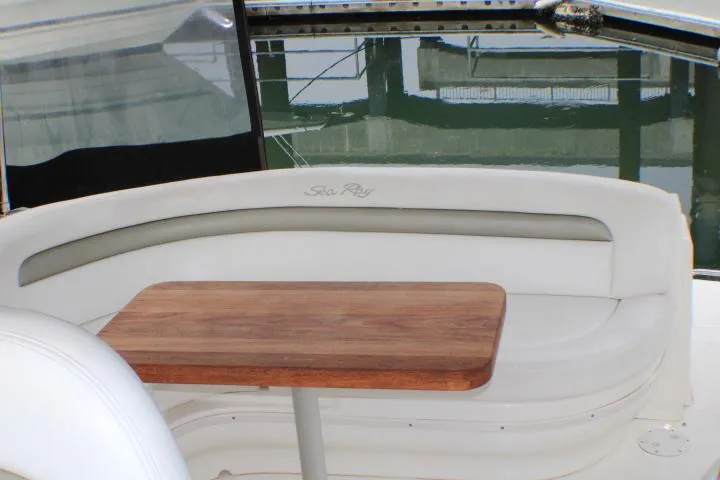 Slide: The Image of 2007 Sea Ray 340 Sundancer interior with white seating and wooden table. - 13