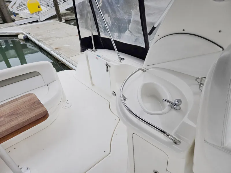 Slide: The Image of 2007 Sea Ray 340 Sundancer boat interior with sink and seating at dock. - 14