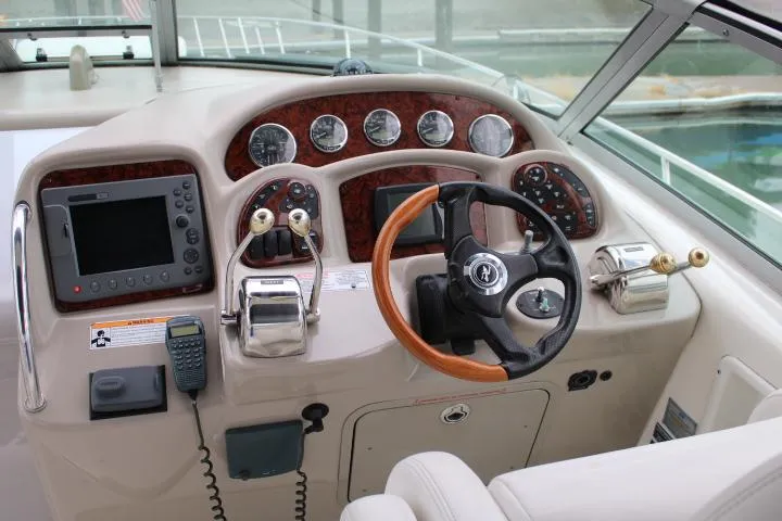 Slide: The Image of 2007 Sea Ray 340 Sundancer helm with steering wheel, gauges, and navigation equipment. - 16