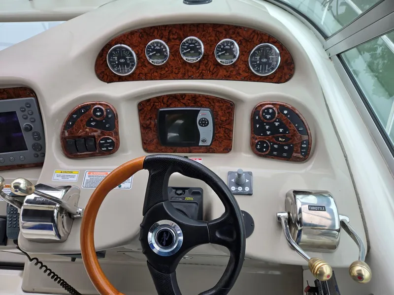 Slide: The Image of Dashboard of a 2007 Sea Ray 340 Sundancer boat with gauges and controls. - 17