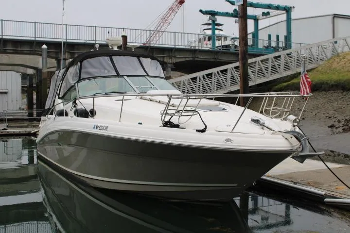 Slide: The Image of 2007 Sea Ray 340 Sundancer docked at a marina, featuring sleek design and American flag. - 2