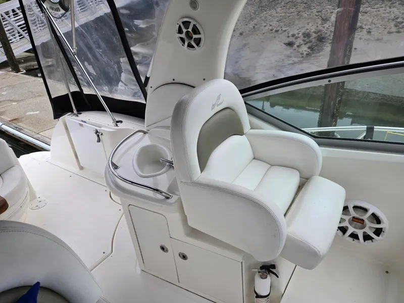 Slide: The Image of 2007 Sea Ray 340 Sundancer cockpit with white seating and speaker system. - 24