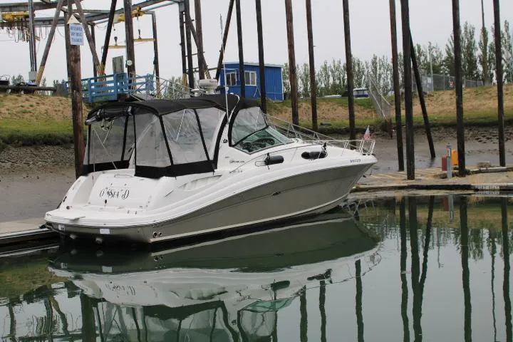 Slide: The Image of 2007 Sea Ray 340 Sundancer docked in a marina, reflecting on calm water. - 3