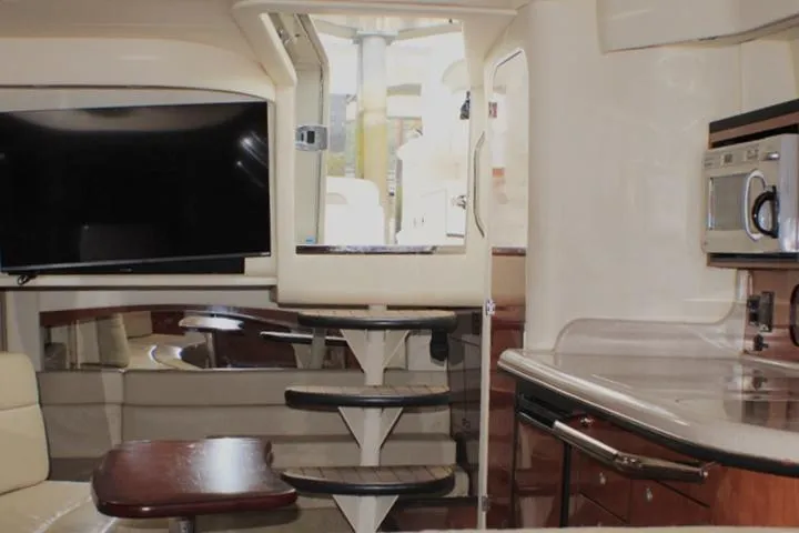 Slide: The Image of Interior of 2007 Sea Ray 340 Sundancer yacht with TV, kitchenette, and stairs. - 33