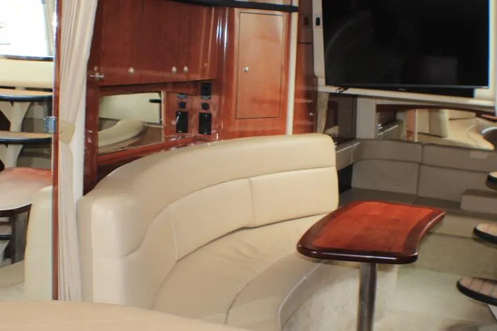 Slide: The Image of Interior of 2007 Sea Ray 340 Sundancer with beige seating and wooden accents. - 36