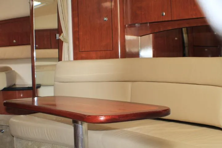 Slide: The Image of Interior of 2007 Sea Ray 340 Sundancer with beige seating and wooden table. - 37