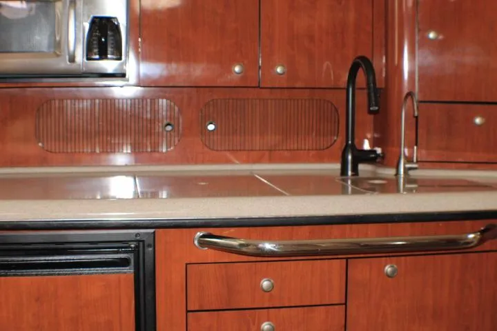 Slide: The Image of Interior view of 2007 Sea Ray 340 Sundancer kitchen with wood cabinets and modern fixtures. - 39