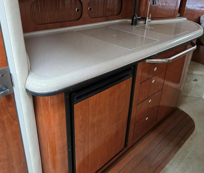 Slide: The Image of 2007 Sea Ray 340 Sundancer interior kitchen with wood cabinetry and countertop. - 41