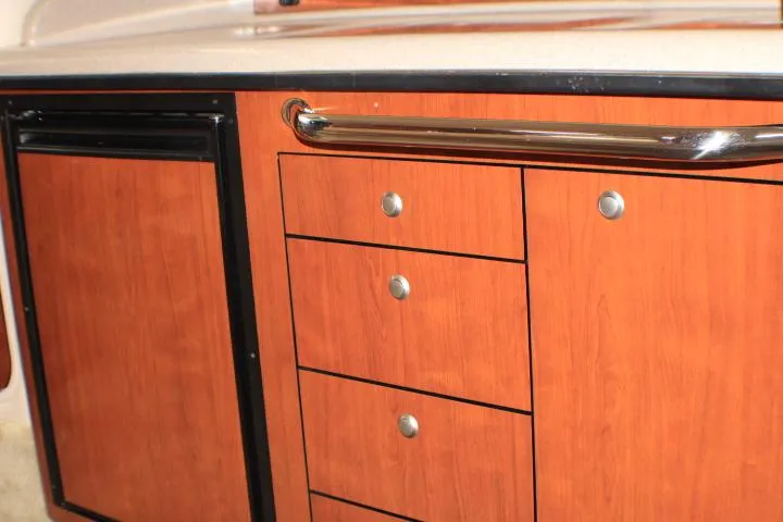 Slide: The Image of Wooden cabinetry with drawers and handle on a 2007 Sea Ray 340 Sundancer boat. - 46